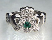Claddagh ring with round emerald and 18 diamond melee