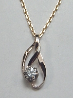 Tri-color gold free form diamond pendant with .62ct diamond
