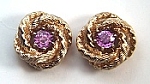 Round pink sapphire stud earrings with 14kt yellow gold jackets.
