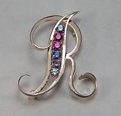 Open R monogram pin with 2.5mm gemstones