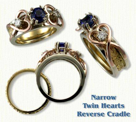 Twin Heart Reverse Cradle set with a round blue sapphire and two side diamonds. Shown in 14kt White Rails, Yellow Triangle Heart Knot Inside Band, and Rose Gold Hearts.