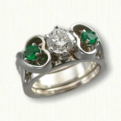 Twin Hearts 09: Twin Hearts Reverse Cradle with an .80ct round diamond and two pear emeralds set in the sides 