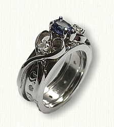 Twin Hearts 05: 14Kt white gold Twin Heart Reverse Cradle set with 7x5mm pear shaped Chatam Sapphire and two side diamonds 